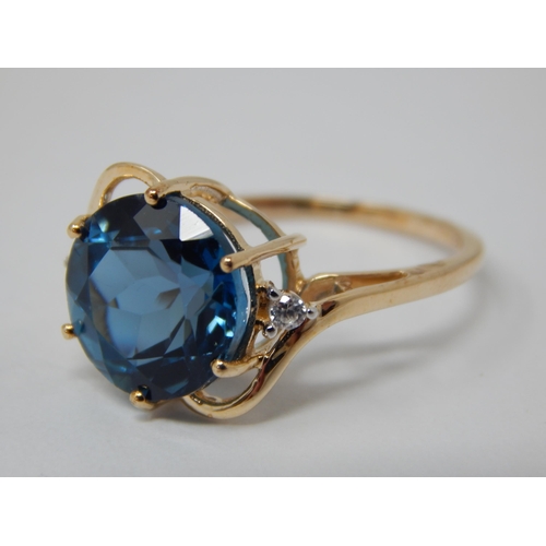 450 - 9ct Ring Set with a Central Marambaia Blue Topaz with White Zircon Accents: Topaz Weight 6.25cts: Ri... 