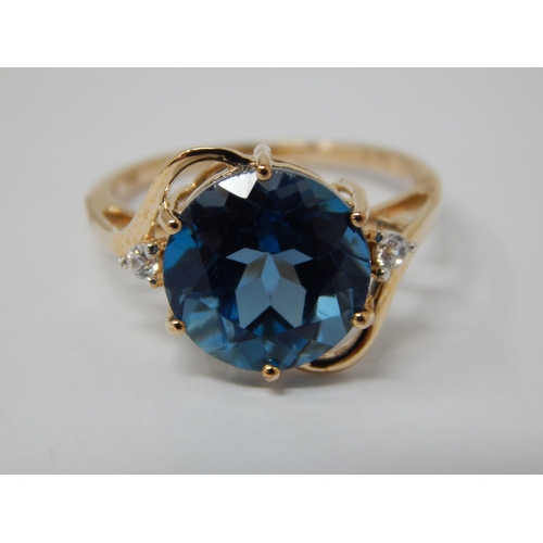 450 - 9ct Ring Set with a Central Marambaia Blue Topaz with White Zircon Accents: Topaz Weight 6.25cts: Ri... 