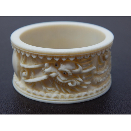 647 - A Deep Carved Late C19th/Early C20th Chinese Ivory Napkin Ring Depicting a Dragon