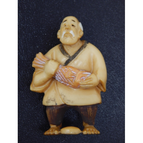 653 - Signed Japanese polychrome inked Ivory Netsuke in the form of an Elder fishing' 50mm