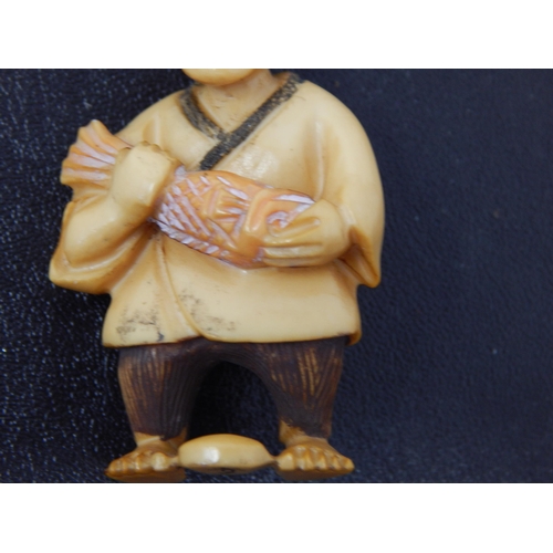 653 - Signed Japanese polychrome inked Ivory Netsuke in the form of an Elder fishing' 50mm