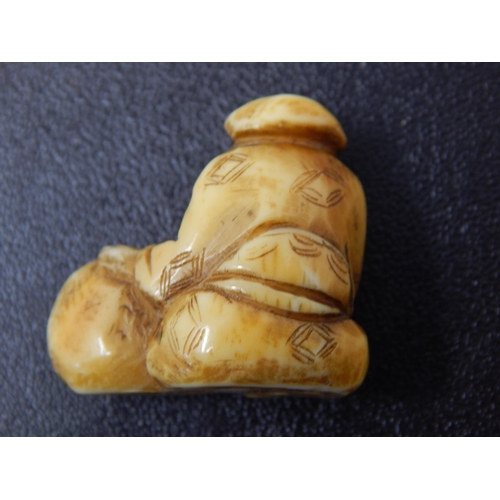 669 - A Late c19th/Early C20th Japanese Meiji Period Ivory Netsuke of a seated man at work: 3 x 2.5cm