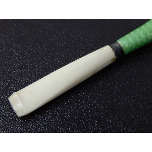 673 - An Art Deco White Metal & Green Guilloche Enamel Cigarette Holder: Measuring 7cm