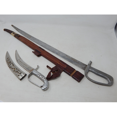 557 - Cast Sword with Leather Scabbard 66cm together with a Dagger & Scabbard 28cm