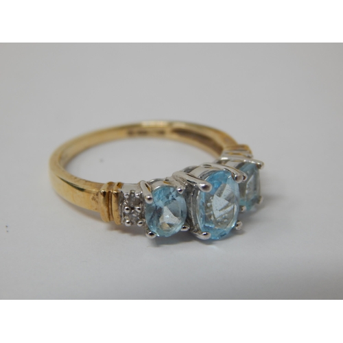 333 - 9ct Yellow Gold Ring Set with Three Aquamarines Flanked either side by Two Diamonds: Size M 1/2