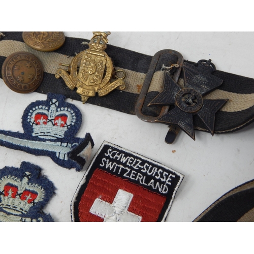 565 - Snake Belt with attached Military Badges & Buttons together with a further quantity of Military Badg... 