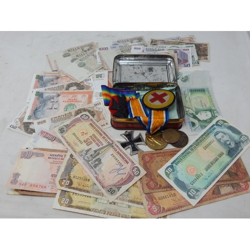 65 - Vintage Tin containing a collection of War Medals and a collection of banknotes