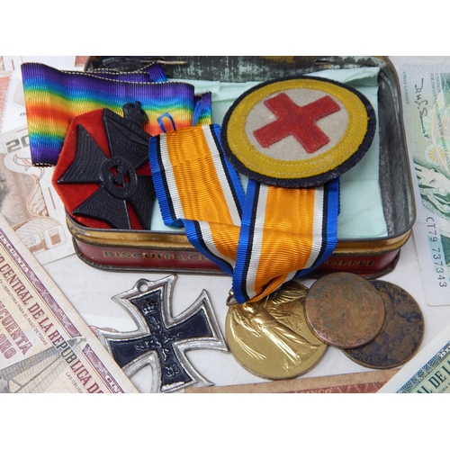 65 - Vintage Tin containing a collection of War Medals and a collection of banknotes