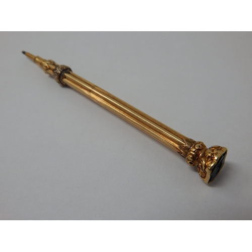 24 - A vintage Gold Propelling pencil in 14ct Gold gross weight 13g; An amber cigarette holder with Gold ... 