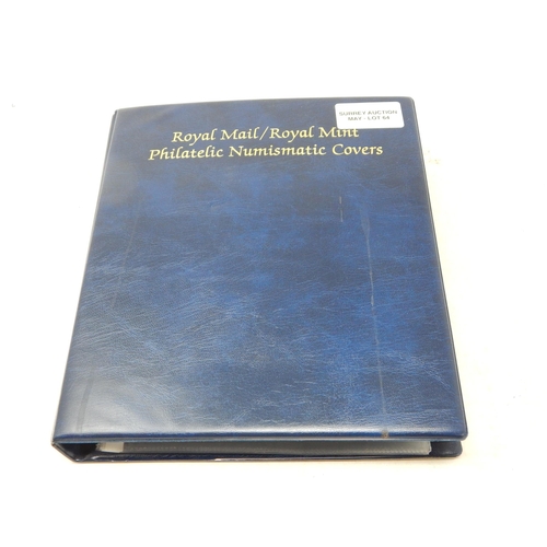 64 - Collection of Royal Mail/Royal Mint Philatelic Numismatic Covers housed in a blue collectors album