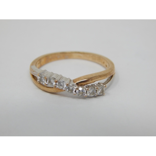 257 - 9ct Yellow Gold Diamond Crossover Ring Set with Seven Diamonds: Ring Size K: Gross weight 1.7g