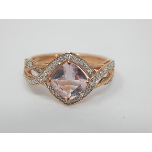 263 - 9ct Rose Gold Ring Set with a Central Pink Topaz within a Diamond Border: Ring Size M: Gross weight ... 