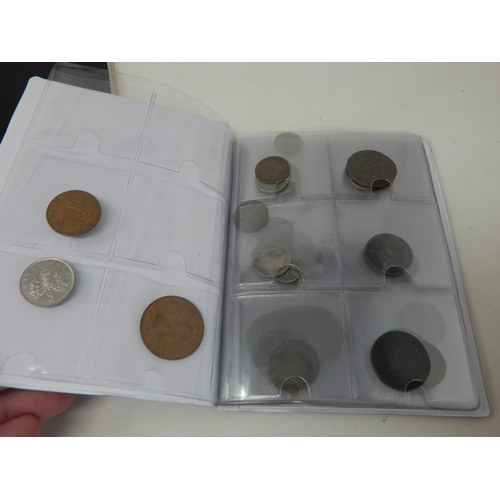 128 - A large collection of coins housed in 4 collectors albums