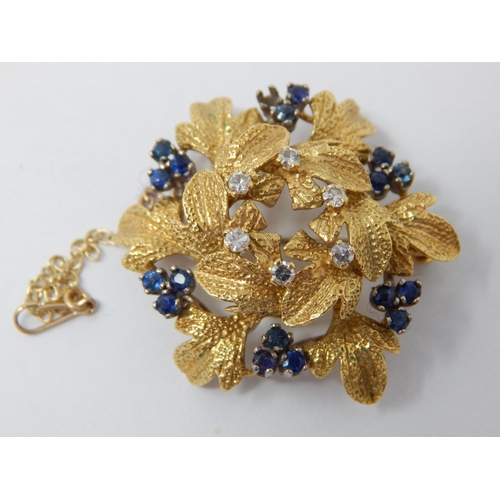 294 - 18ct Gold Diamond & Sapphire Set Flower Brooch: Gross weight 12g. (One Stone Vacant)