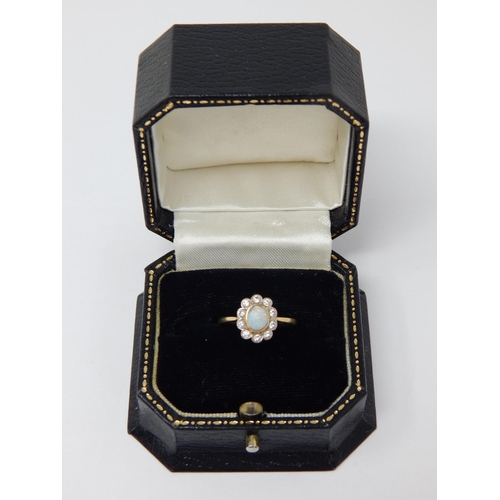 296 - 18ct Yellow Gold Ring Set with a Central Opal within a Border of 10 Diamonds: Ring Size K: Gross wei... 