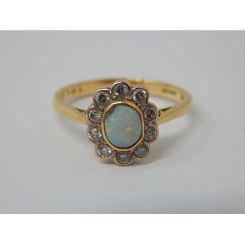 296 - 18ct Yellow Gold Ring Set with a Central Opal within a Border of 10 Diamonds: Ring Size K: Gross wei... 