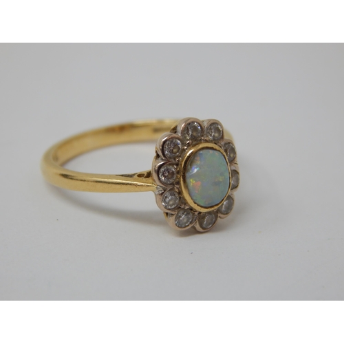 296 - 18ct Yellow Gold Ring Set with a Central Opal within a Border of 10 Diamonds: Ring Size K: Gross wei... 