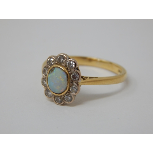 296 - 18ct Yellow Gold Ring Set with a Central Opal within a Border of 10 Diamonds: Ring Size K: Gross wei... 