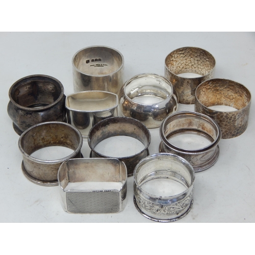 343 - 11 x Hallmarked Silver Napkin Rings: Various Dates & Makers: Weight 286g