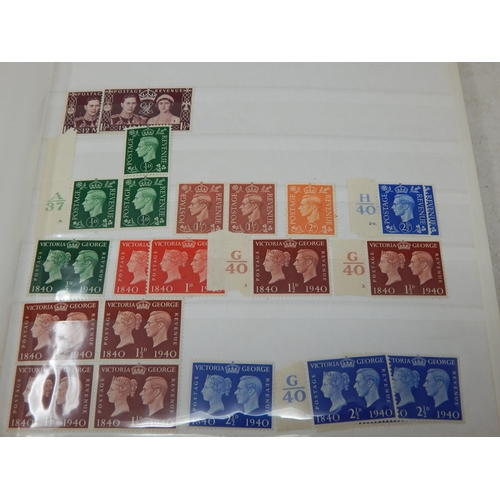 100 - A red stock book containing a massive collection of Mint GB Stamps from King Edward VII to QEII incl... 