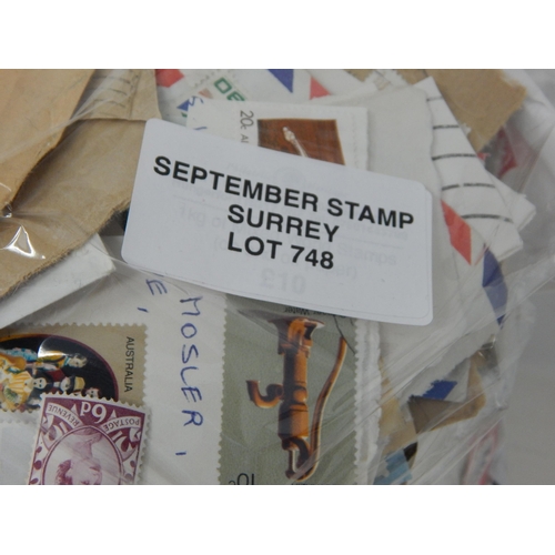 748 - An assortment of World used stamps on and off paper. 1kg in weight