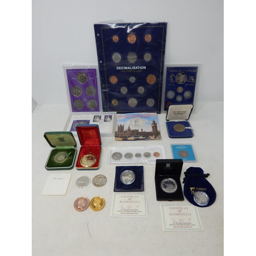 Large collection of coinage to include: Decimal First and Last set in Change Checker Fiolder; Royal Silver Wedding Anniversary FDC Coin and Stamp Set in Sandhill case; 1972 Proof Silver Crown in case; 1984 Olympics coin set in case; UK 1982 Uncirculated coin collection in Royal Mint blister pack; 1977 Silver Jubilee Crown gilded in pendant; Set of 1965-1981 Crowns in Sandhill case; USA Kennedy Half Dollar coin set 1997 to one cent in plastic case; Turks and Caicos Islands 1969 One Crown in Royal Mint case; Gibraltar 2019 diamond finish 50p in Pobjoy pouch; pair of Proof Waterloo medallions; Poland 20 Zlote 1979 cased; USA Olympic Atlanta Clad Half Dollars Proof 1996 with COAs (2); 1995 Pattern 25 Ecu coin; Isle of Man 1978 Crown in case (lot)