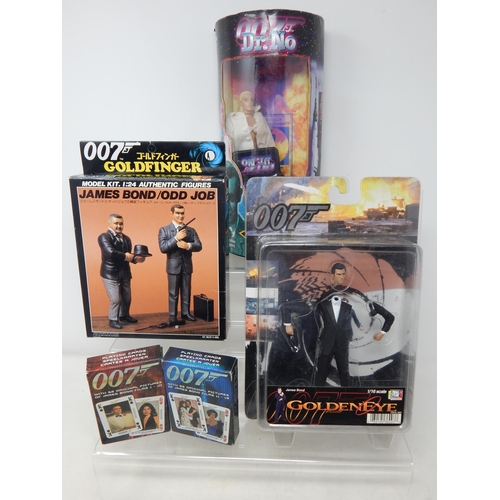 597 - 007 James Bond Figures & Model Kit together with Two Packs of 007 Playing Cards.