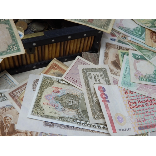 46 - A vintage Ceylon casket containing a large range of coinage and banknotes twinned with a vintage alb... 