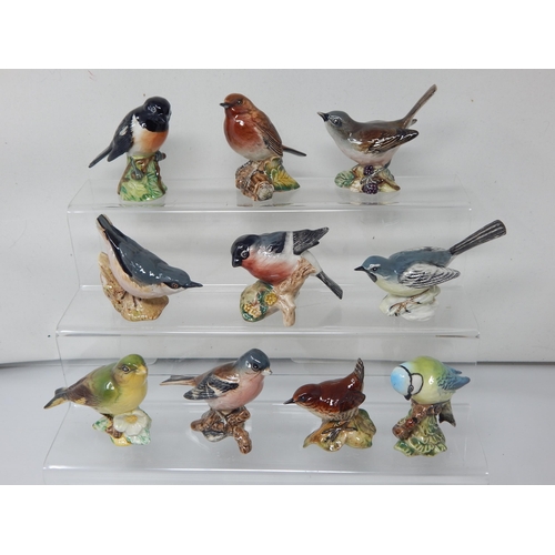 A Collection of 10 Beswick Bird Figures Including: Grey Wagtail, Greenfinch, Robin, Whitethroat, Wren, Stonechat, Chaffinch, Blue Tit, Nuthatch & Bullfinch