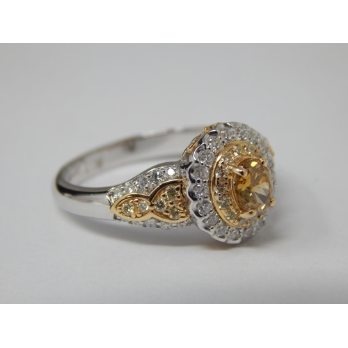 18ct Two Tone Gold Ring Set with a Central Yellow Diamond 0.52cts within a White Diamond Border & Shoulders: Total Diamond Weight 1.12cts. Ring Size N/): Gross weight 4.56g: with C.O.A