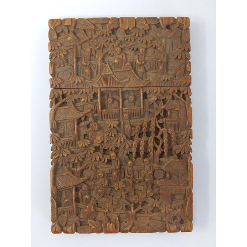 C19th Cantonese Wooden Card Case with all over carving depicting figures & pagodas within a wooded landscape: Bearing the carvers signature translated as "Ri Long" Measures 11.6cm x 7.5cm