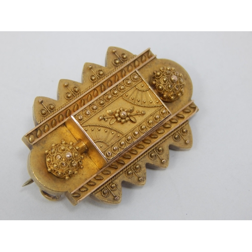 78 - A Victorian Yellow Metal Mourning Brooch with reverse Hair Panel: 4cm wide: Gross weight 11.16g