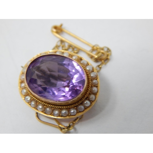 87 - Victorian 9ct Gold Brooch Set with a Central Amethyst within a Seed Pearl Border with safety Chain.