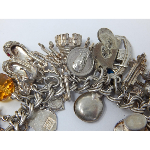 162 - Heavy Silver Charm Bracelet with Numerous Attached Charms: Gross weight 105g