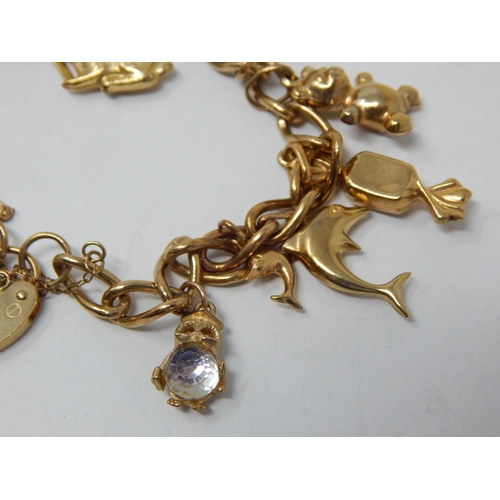 163 - 9ct Yellow Gold Charm Bracelet with Numerous Attached Charms: Gross weight 22.03g