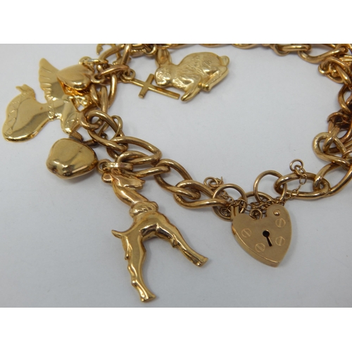 163 - 9ct Yellow Gold Charm Bracelet with Numerous Attached Charms: Gross weight 22.03g