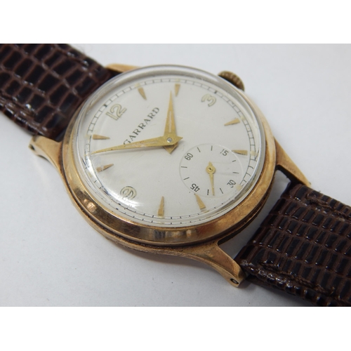 169 - GARRARD: Gentleman's 9ct Gold Wristwatch with subsidiary seconds dial on brown leather strap. Workin... 