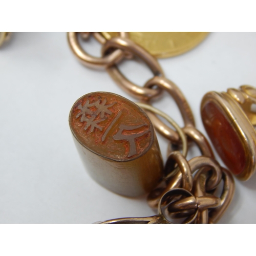 381 - Heavy 9ct Yellow Gold Charm Bracelet with attached 22ct Gold One Pond Coin 1898: 11 x Seal Fobs & Ba... 