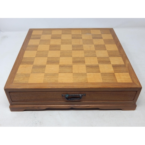 612 - Chess Set: The Pieces Carved from Soapstone & contained within a drawered chess board cabinet