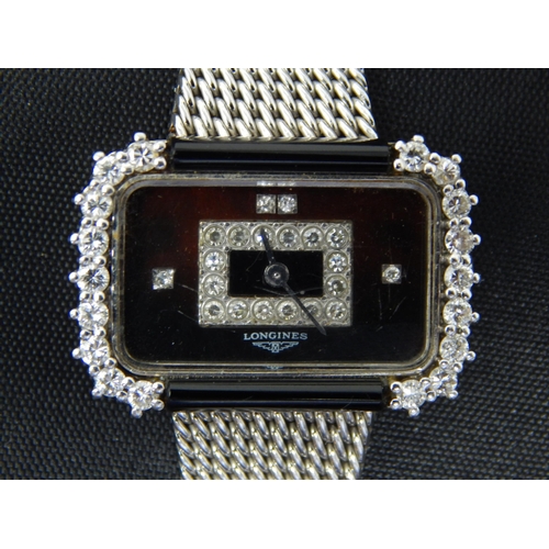 18ct White Gold Longines Wristwatch with 18ct White Gold Strap: The Rectangular Black Dial Set with an Inner panel of 16 Diamonds with Diamond Markers @ 3. 9 & 12 O'clock. The Outer Diamond Bezel Set with a Further 18 Diamonds: Gross weight 43.45g: Working when catalogued