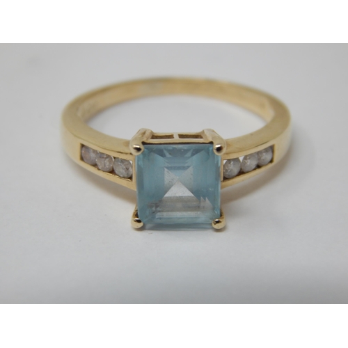 291 - 9ct Yellow Gold ring Set with a Central Aquamarine Flanked either side with 3 Diamonds: Ring Size M:... 