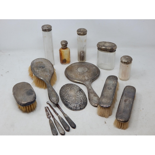 176 - A Quantity of Silver Mounted Dressing Table Jars, Hand Mirror & Brushes: Various Dates & Makers