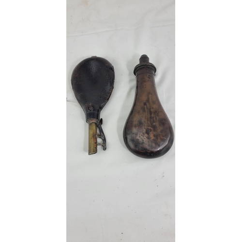 526 - Two antique powder flasks