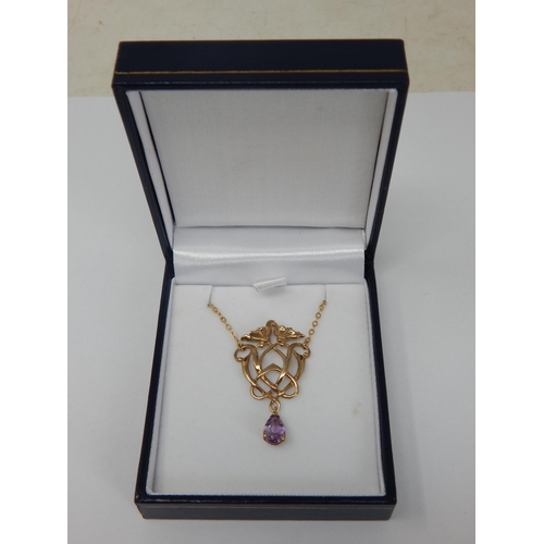 9ct yellow gold Art Nouveau-style necklace set with 
amethysts in an openwork pendant, boxed. 
Amethysts 0.85ct approx