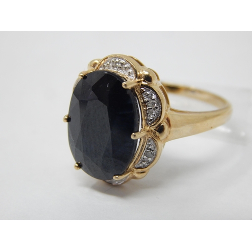 15 - 9ct Yellow Gold Ring Set with a Large Central Black Stone within a Diamond Border: Gross weight 4.61... 