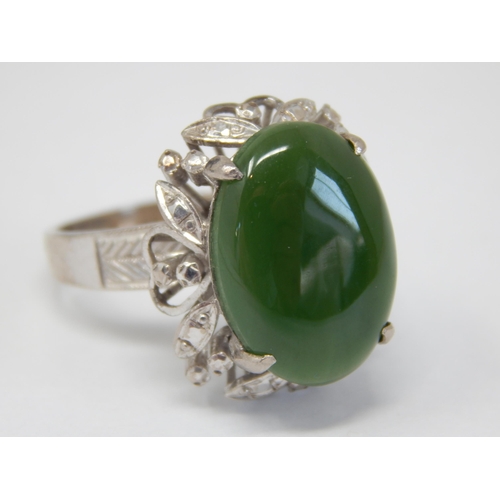 61 - 18ct White Gold Ring Set with a Central Jade Cabochon: Ring Size Q: Gross weight 9.22g