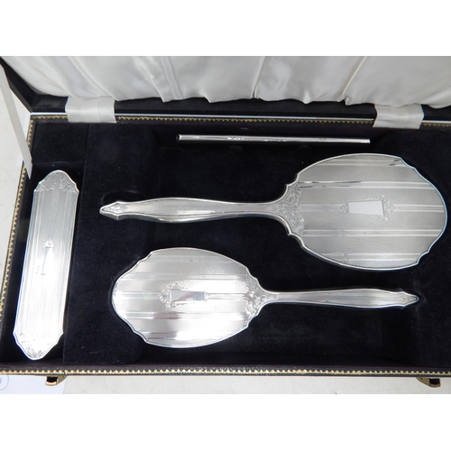 100 - Cased set of Elizabeth II silver four piece dressing table set,
Birmingham 1964,