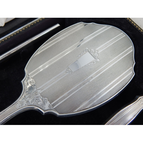 100 - Cased set of Elizabeth II silver four piece dressing table set,
Birmingham 1964,