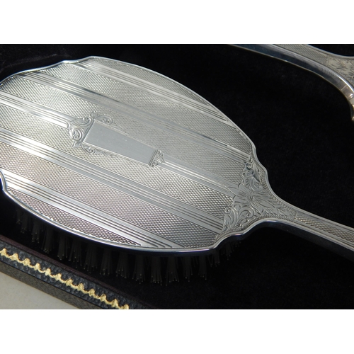 100 - Cased set of Elizabeth II silver four piece dressing table set,
Birmingham 1964,