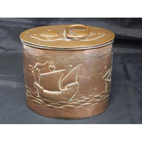 494 - An Arts & Crafts Newlyn oval tea caddy, the cover with swing handle and applied strapwork decorated ... 